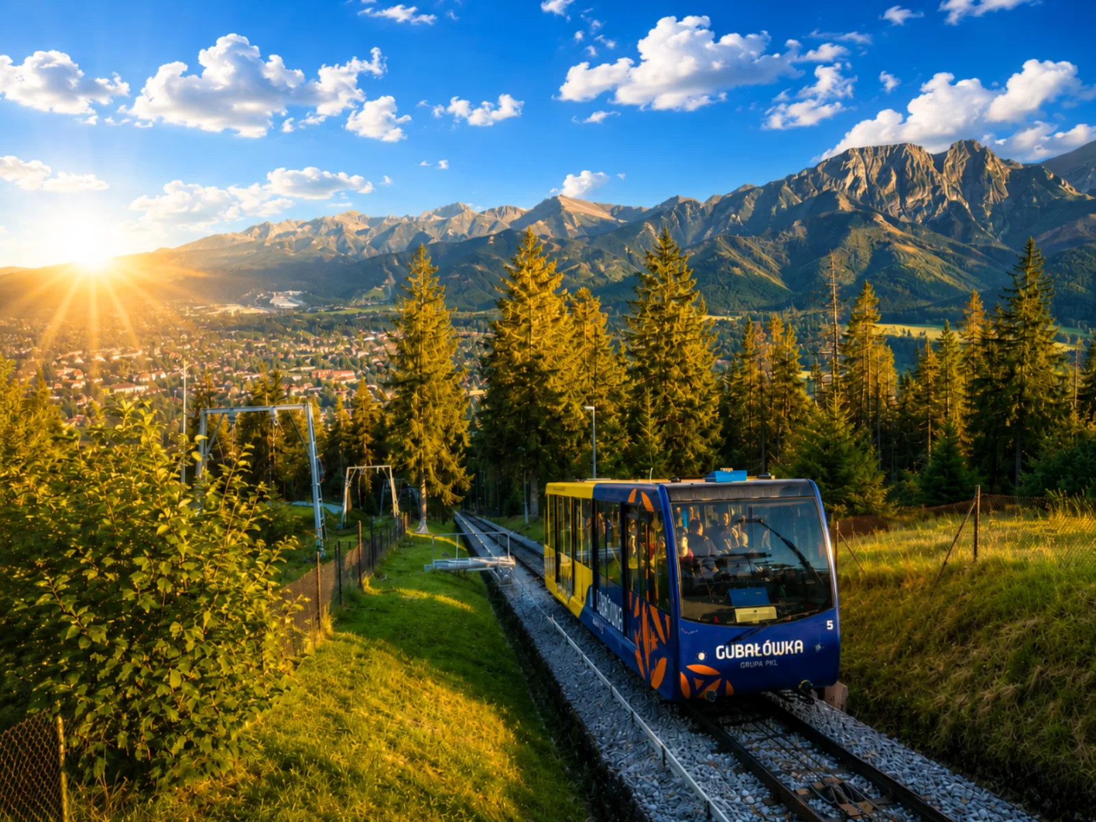Gubałówka funicular car climbing past spruces with Tatra peaks at sunset