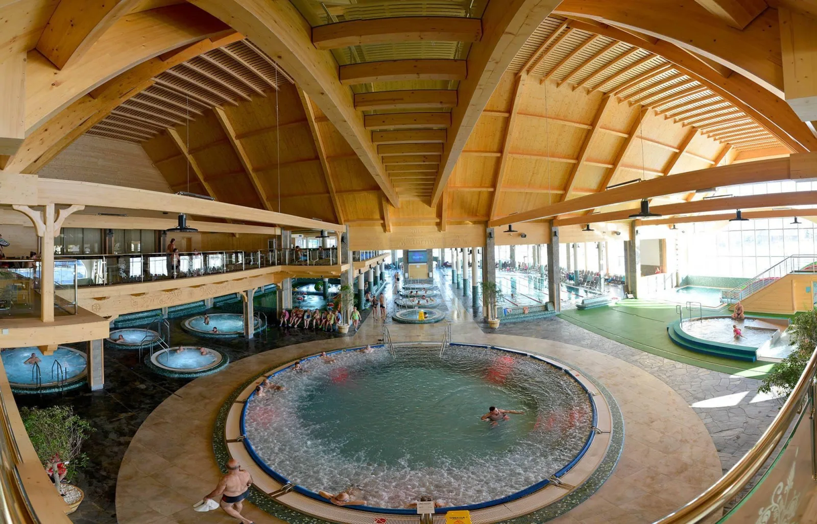Indoor whirlpools beneath a large curved timber roof