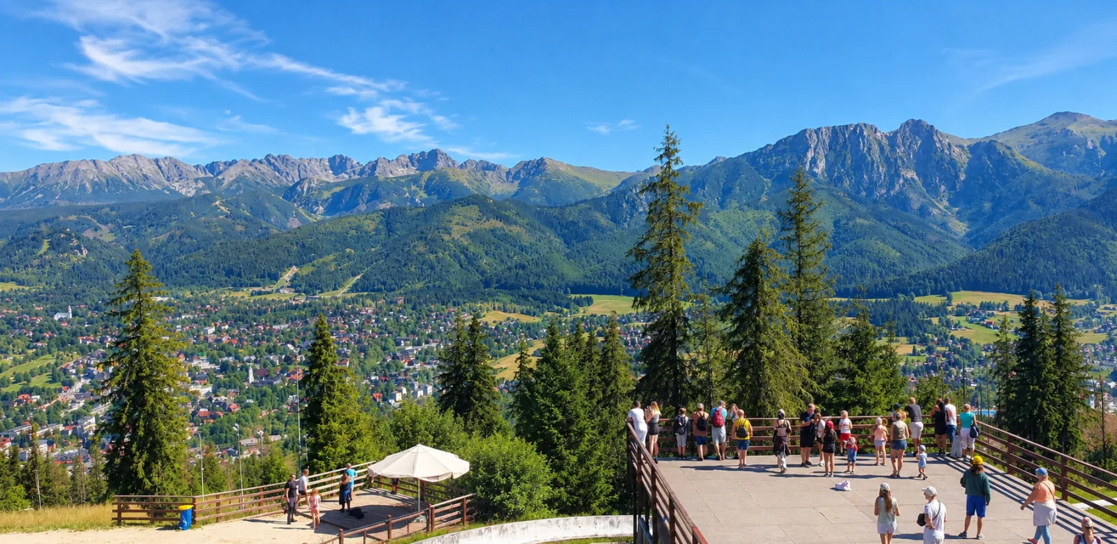 Visitors on a viewing platform above Zakopane looking towards the Tatras
