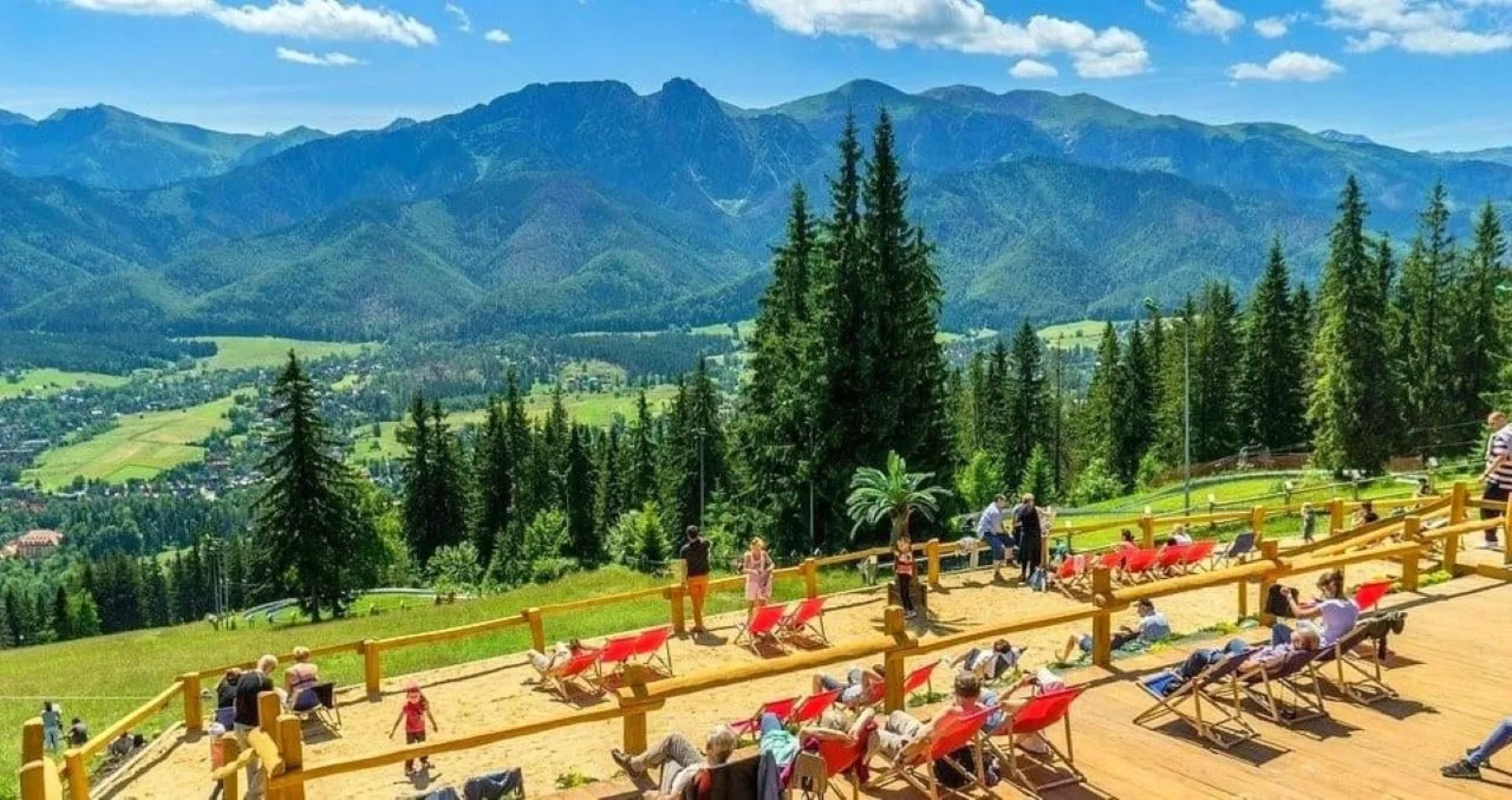 Deckchairs on a hilltop terrace overlooking Zakopane and the Tatras