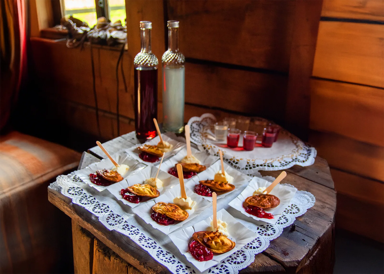 Grilled cheese with cranberry and bottles of spirits in a wooden hut