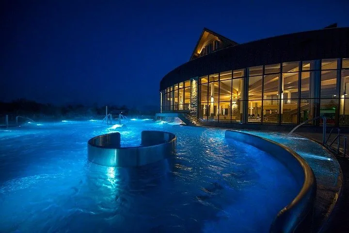 Steaming outdoor pool at night with a round seating ring